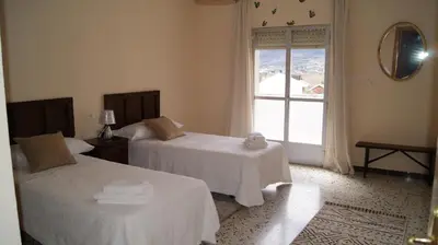 a hotel room with two beds and a window at Dona Branca in Quiroga
