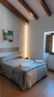 a bedroom with a bed with two towels on it at Hostal A Cantina de Renche in Renche