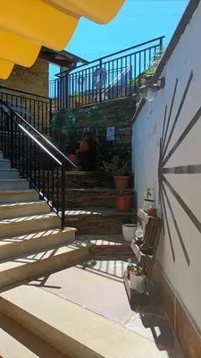 a set of stairs with a bench and a railing at Hostal A Cantina de Renche in Renche