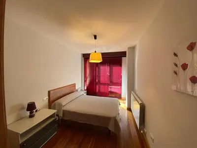 a small bedroom with a bed and a window at dpCristal LikeHome in Sarria