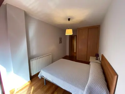 a small bedroom with a bed and a cabinet at dpCristal LikeHome in Sarria