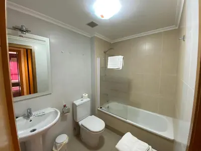 a bathroom with a sink and a toilet and a bath tub at dpCristal LikeHome in Sarria