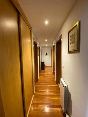 a long hallway with wooden floors and a hallwayngth at dpCristal LikeHome in Sarria