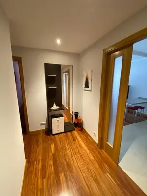 an empty living room with wooden floors and an open door at dpCristal LikeHome in Sarria
