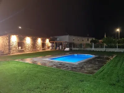 a swimming pool in a yard at night at Casa Grilo in Monforte de Lemos