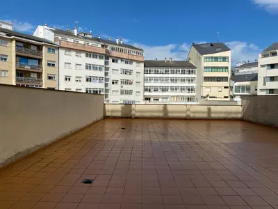 a view of a rooftop with buildings in the background at Pensión Abeledo in Sarria