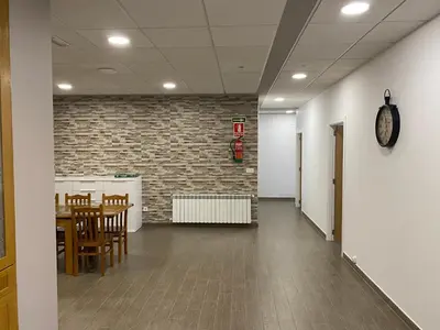 a dining room with a table and a brick wall at dpCristal El Rinconcito in Sarria
