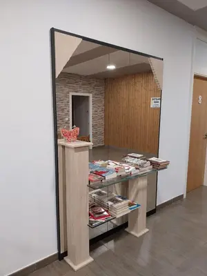a mirror in a room with a shelf with books at dpCristal El Rinconcito in Sarria