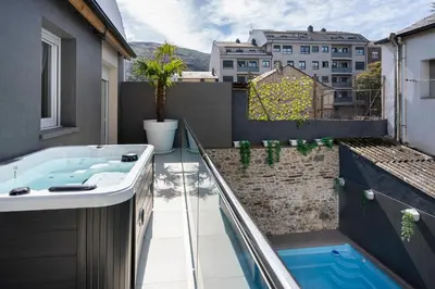 a hot tub on the balcony of a building at Alojamiento Barco de Valdeorras in Vegamolinos