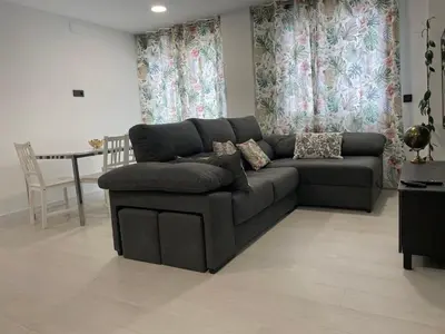 a living room with a couch and a table at Alojamiento Barco de Valdeorras in Vegamolinos