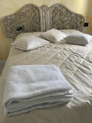 a bed with white blankets and pillows on it at Alojamiento Barco de Valdeorras in Vegamolinos