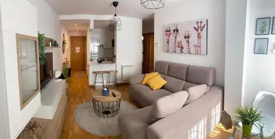 a living room with a couch and a kitchen at VIANA in Monforte de Lemos
