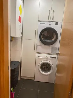 a washing machine and a washer in a kitchen at VIANA in Monforte de Lemos