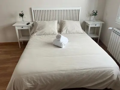 a white bed with a towel on top of it at Casa Manuela in Castro Caldelas