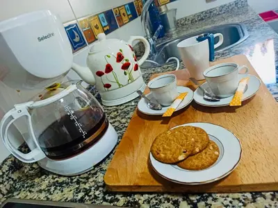 a counter with a cutting board with cookies and a blender at Casa Naseiro in Melide