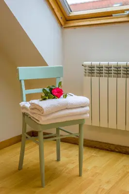 a green chair with a flower on top of it at Casa Naseiro in Melide