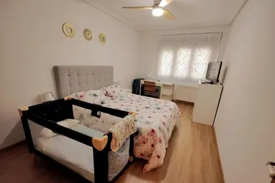 a bedroom with a bed and a desk and a window at Céntrico, 100 metros de la playa, reformado,163 m2 in Foz