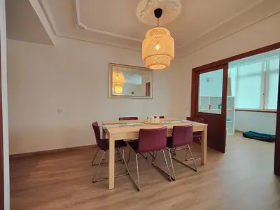 a dining room with a wooden table and purple chairs at Céntrico, 100 metros de la playa, reformado,163 m2 in Foz