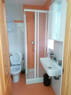 a bathroom with a toilet and a sink at NIDO in Ribadeo