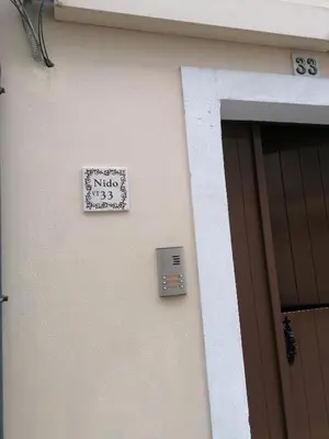 a sign on the side of a building next to a door at NIDO in Ribadeo