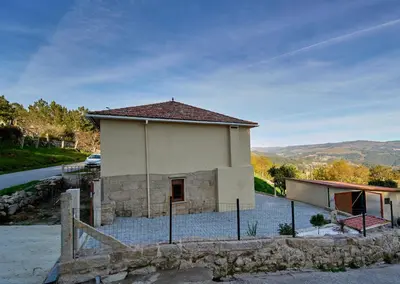 a small building with a fence in front of it at O Lar de Lola in Mondariz