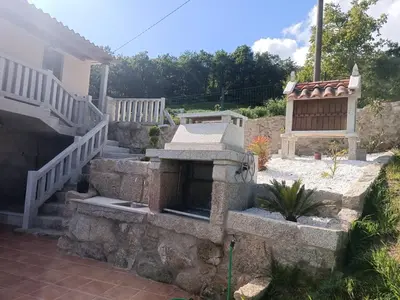 a stone fireplace in a yard with a staircase at O Lar de Lola in Mondariz