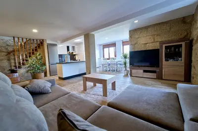 a large living room with a couch and a table at O Lar de Lola in Mondariz