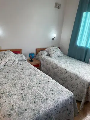 a bedroom with two beds and a window at Chalet casa con piscina en ARBO Vigo in Arbo
