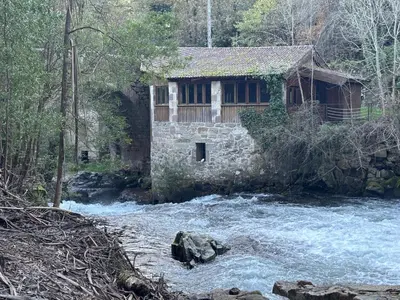 a building in the middle of a river at Chalet casa con piscina en ARBO Vigo in Arbo