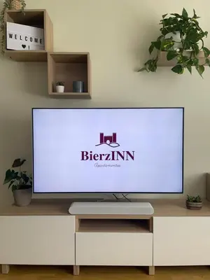 a large flat screen tv sitting on a white entertainment center at BierzINN Alojamientos - Brujas in Ponferrada