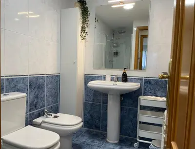 a bathroom with a toilet and a sink and a mirror at BierzINN Alojamientos - Brujas in Ponferrada