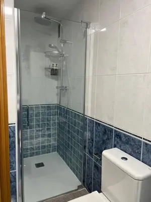 a bathroom with a glass shower with a toilet at BierzINN Alojamientos - Brujas in Ponferrada