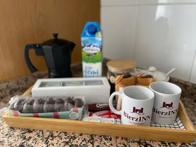 a tray with cups of coffee and donuts on a counter at BierzINN Alojamientos - Brujas in Ponferrada