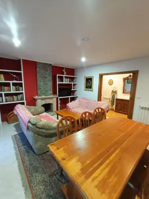 a living room with a table and a couch at O FOGAR DAS FINAS in Melias