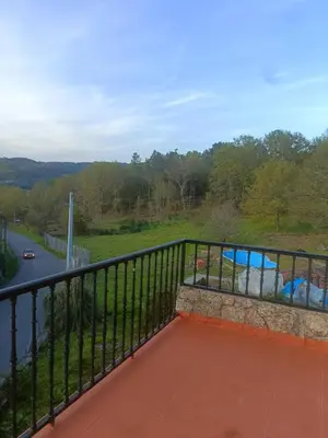 a balcony with a view of a swimming pool at O FOGAR DAS FINAS in Melias