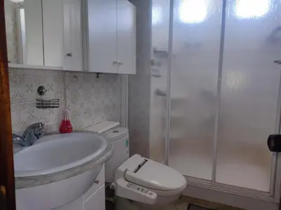 a bathroom with a toilet and a sink and a shower at Casa Jesús in Sarria