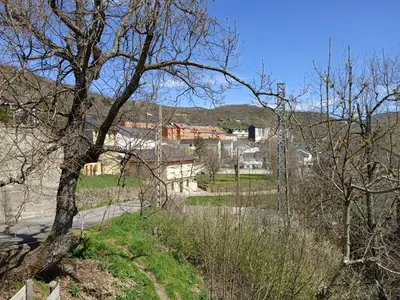 a view of a park with trees and buildings at VUT El Refugio in Villablino