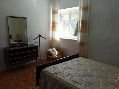 a bedroom with a bed and a dresser and a mirror at VUT El Refugio in Villablino