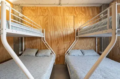two bunk beds in a room with wooden walls at Casona con Jacuzzi in Betanzos