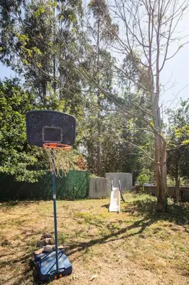 a basketball hoop with a net in a yard at Casona con Jacuzzi in Betanzos