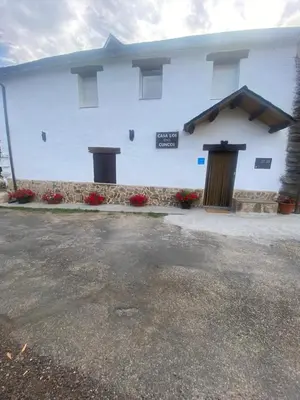 a white building with a sign on the side of it at Casa Los Cuncos in Barrio de Lomba