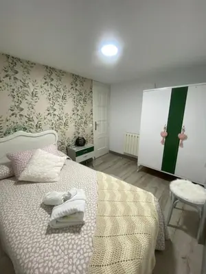 a bedroom with a bed with towels on it at Casa Los Cuncos in Barrio de Lomba