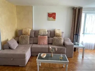 a living room with a couch and a table at Casa Los Cuncos in Barrio de Lomba