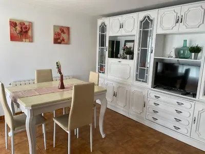 a dining room with a table and a tv at Casa Los Cuncos in Barrio de Lomba