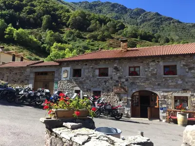 a group of motorcycles parked in front of a building at Apartamentos Rurales CASONA DE LOLO in Caunedo