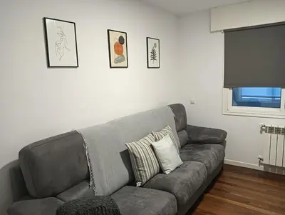 a living room with a couch and a television at O Refuxio de Sigüeiro # a 10 min de Santiago in Sigüeiro