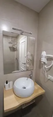 a bathroom with a white sink and a mirror at O Refuxio de Sigüeiro # a 10 min de Santiago in Sigüeiro