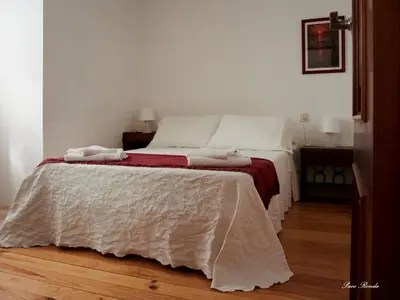 a bedroom with a bed with a blanket on it at Casa de Mila en Creciente Pontevedra in Crecíente