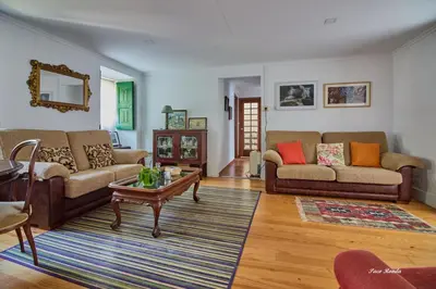 a living room with two couches and a coffee table at Casa de Mila en Creciente Pontevedra in Crecíente