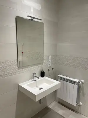 a white bathroom with a sink and a mirror at Casa do Crego in Brañas